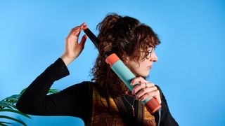 the dyson airwrap ID in teal and terracotta colorway (patina and orange) with a lapis case, with a brush, hairfryer, curling wand attachments