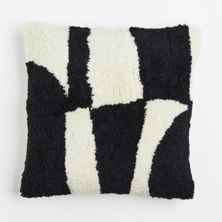 A black and white cushion with a striped pattern