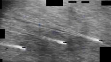 Three ships on a gray sea spot a hovering object in this DoD video