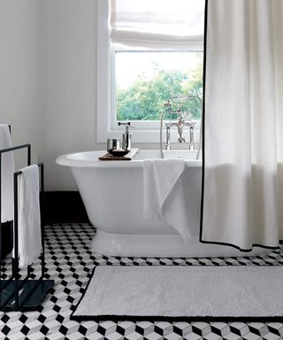 White shower curtain with a black binding around the edge