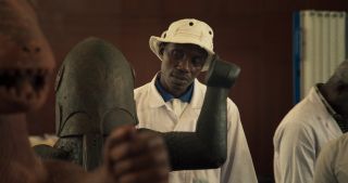 A man stares at a Benin artifact, in the documentary 'Dahomey.'