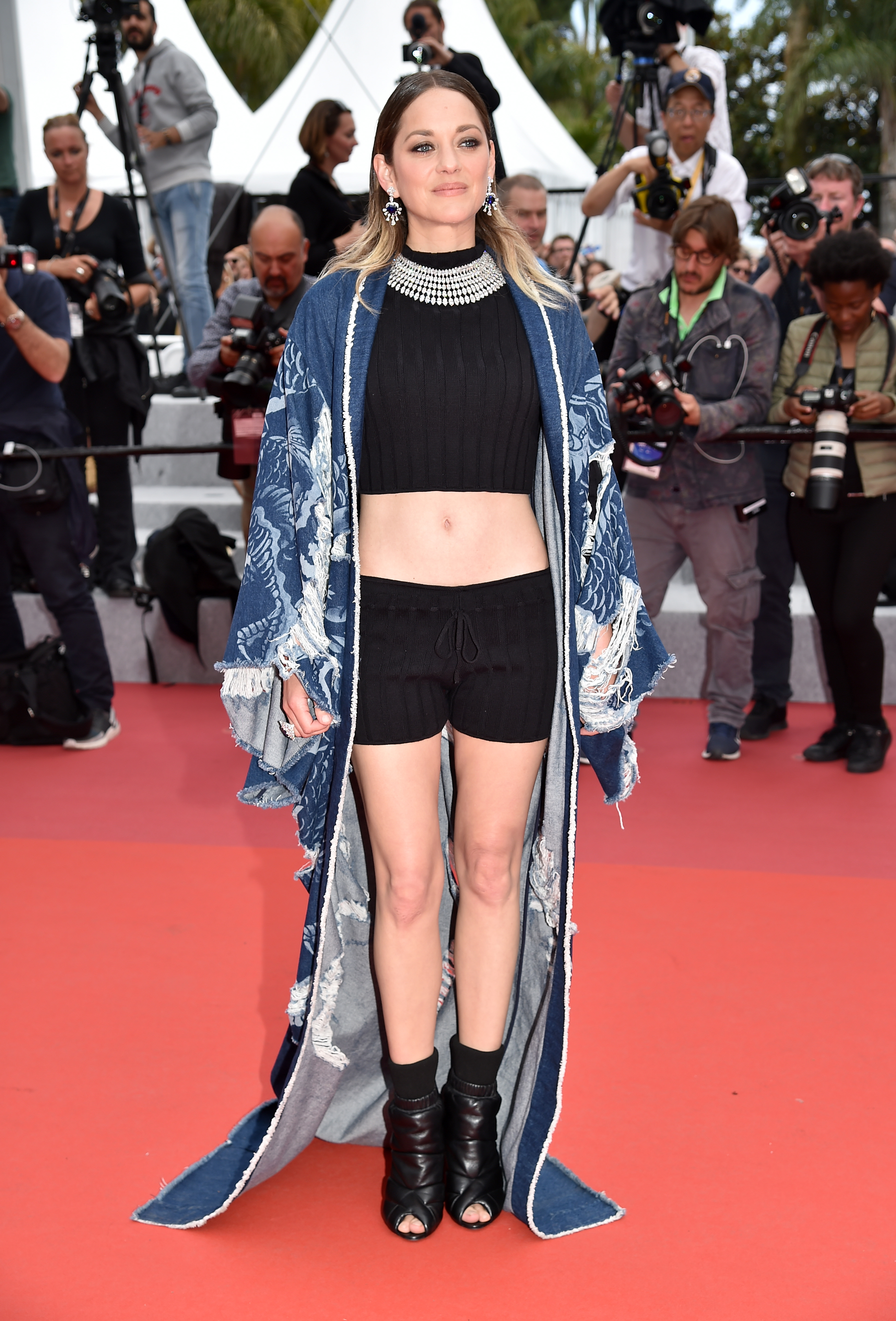 Marion Cotillard on the Cannes Film Festival red carpet wearing short shorts.