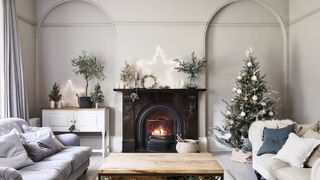 living room with open fire and Christmas tree