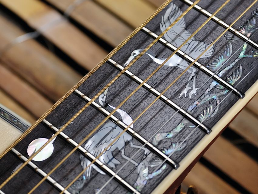 The neck features a distinctive crane overlay.