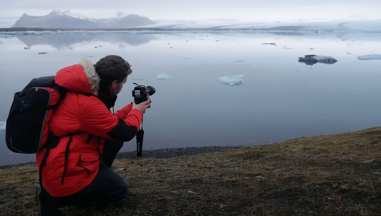 A photographer taking photos at Jökulsarlon in Iceland