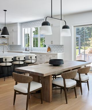 black and white kitchen with wood dining table