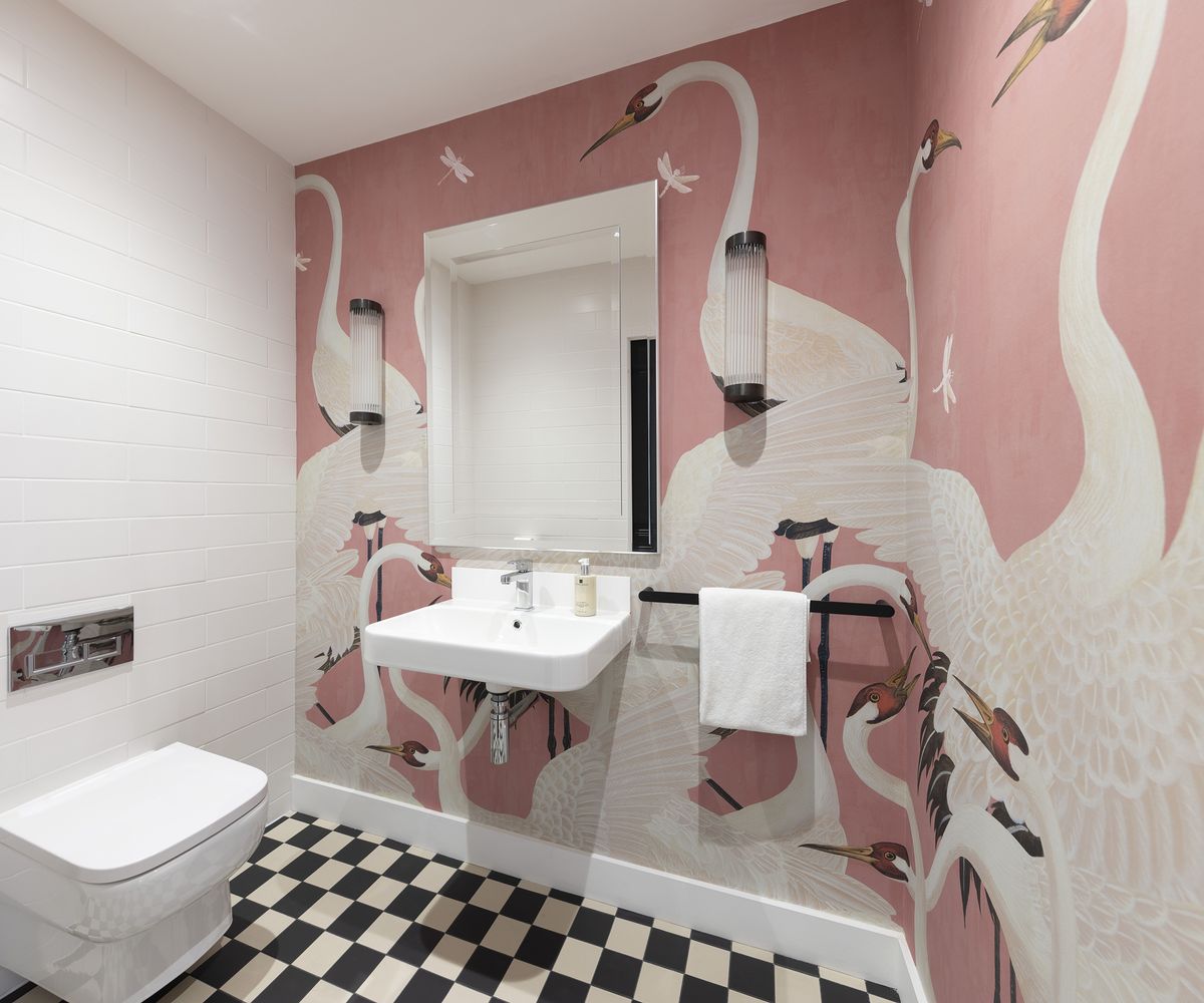 Fun pink wallpaper in a bathroom with bird print