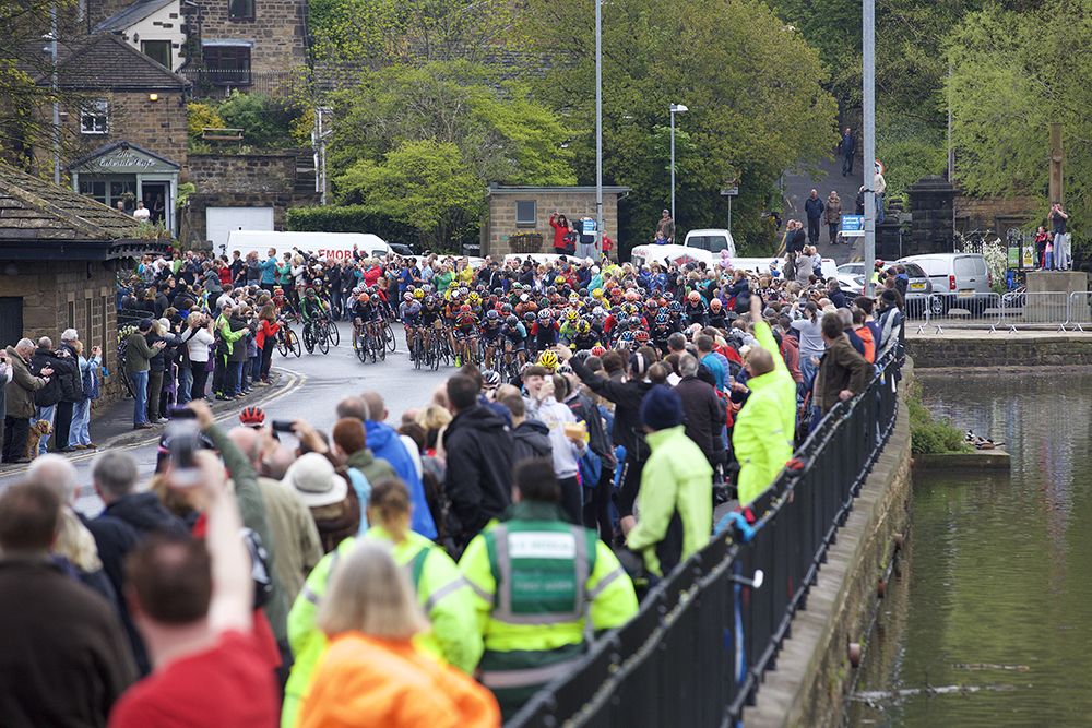 Colourful crowds line the roadside
