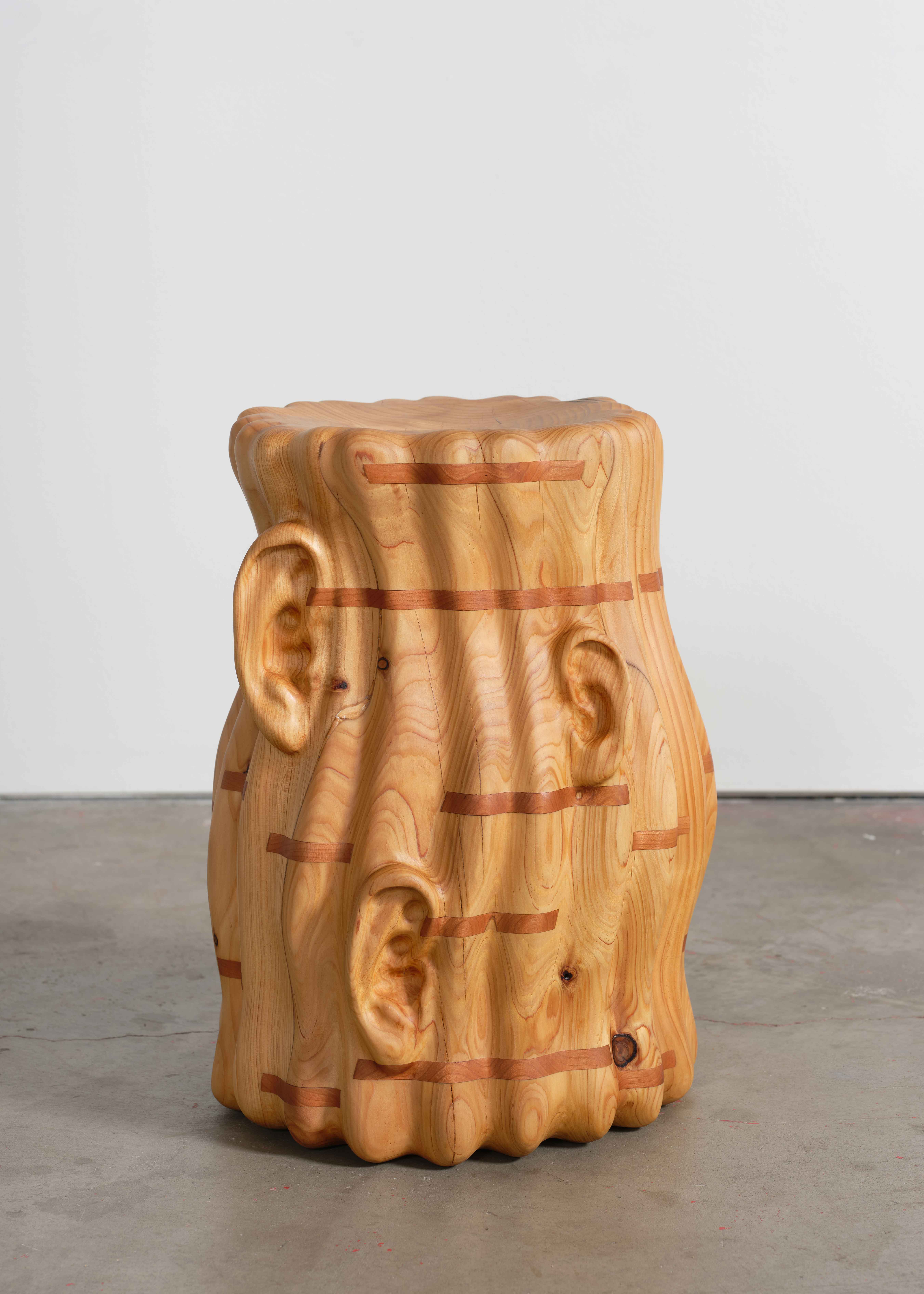 carved wooden stool made from wildfires salvaged wood in LA, and featuring carved ears