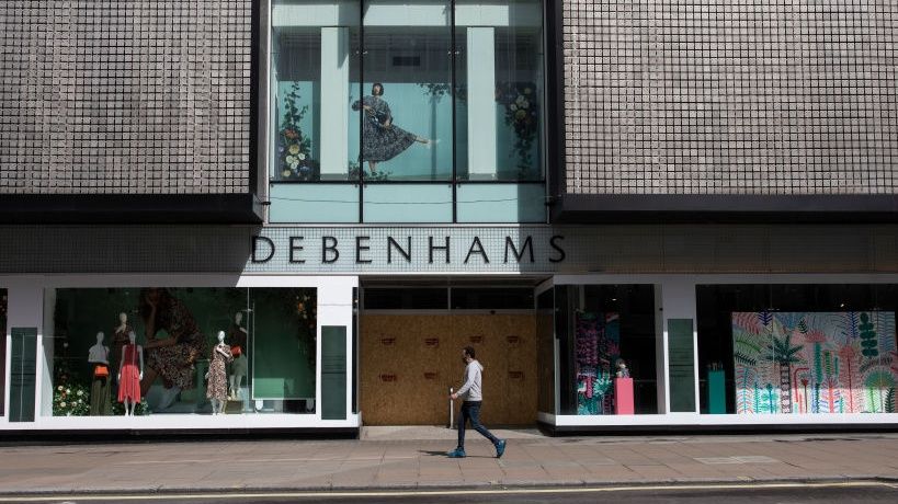 A man walks past a closed Debenhams on Oxford Street, London during the UK coronavirus lockdown.