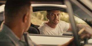 Brian O'Conner (Paul Walker) looks over at Dominic Torretto in Furious 7 (2015)