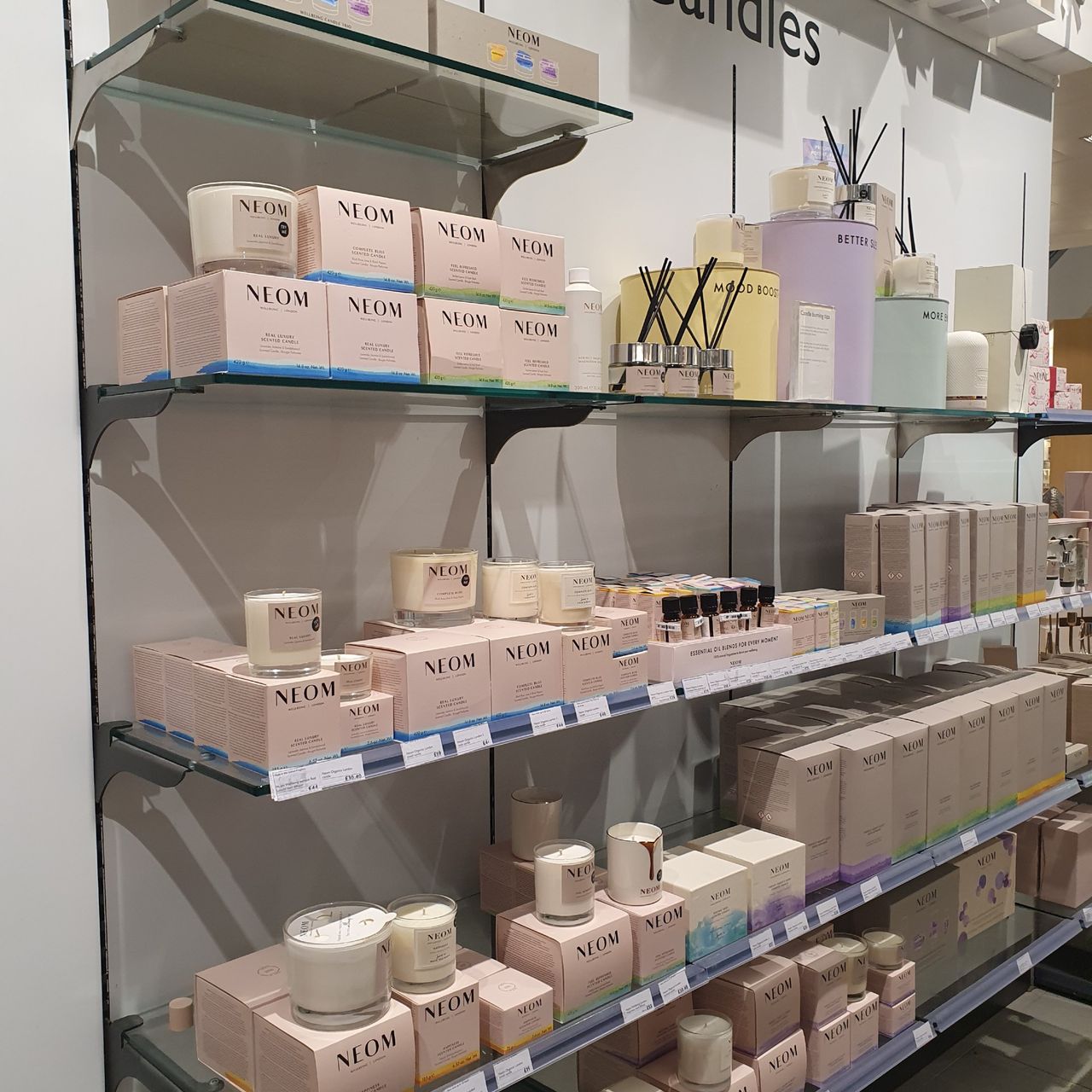 A display of Neom Wellbeing scented candles and diffusers at John Lewis