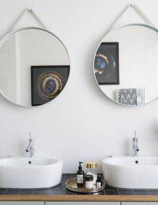 A bathroom with two mirrors above the vanity