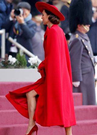 Catherine, Princess of Wales in a red cape dress and hat