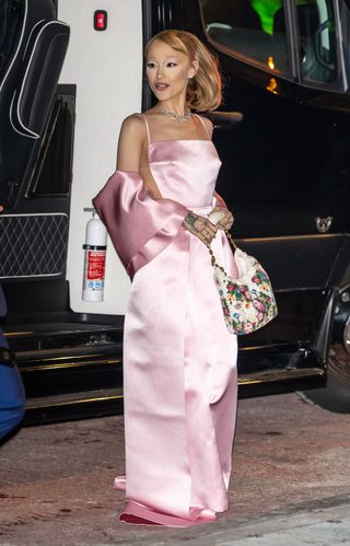 Ariana Grande attends the 2025 National Board of Review Gala at Cipriani 42nd Street on January 07, 2025 in New York City with ethan slater wearing a pink blackess dress and a beaded loewe squeeze bag