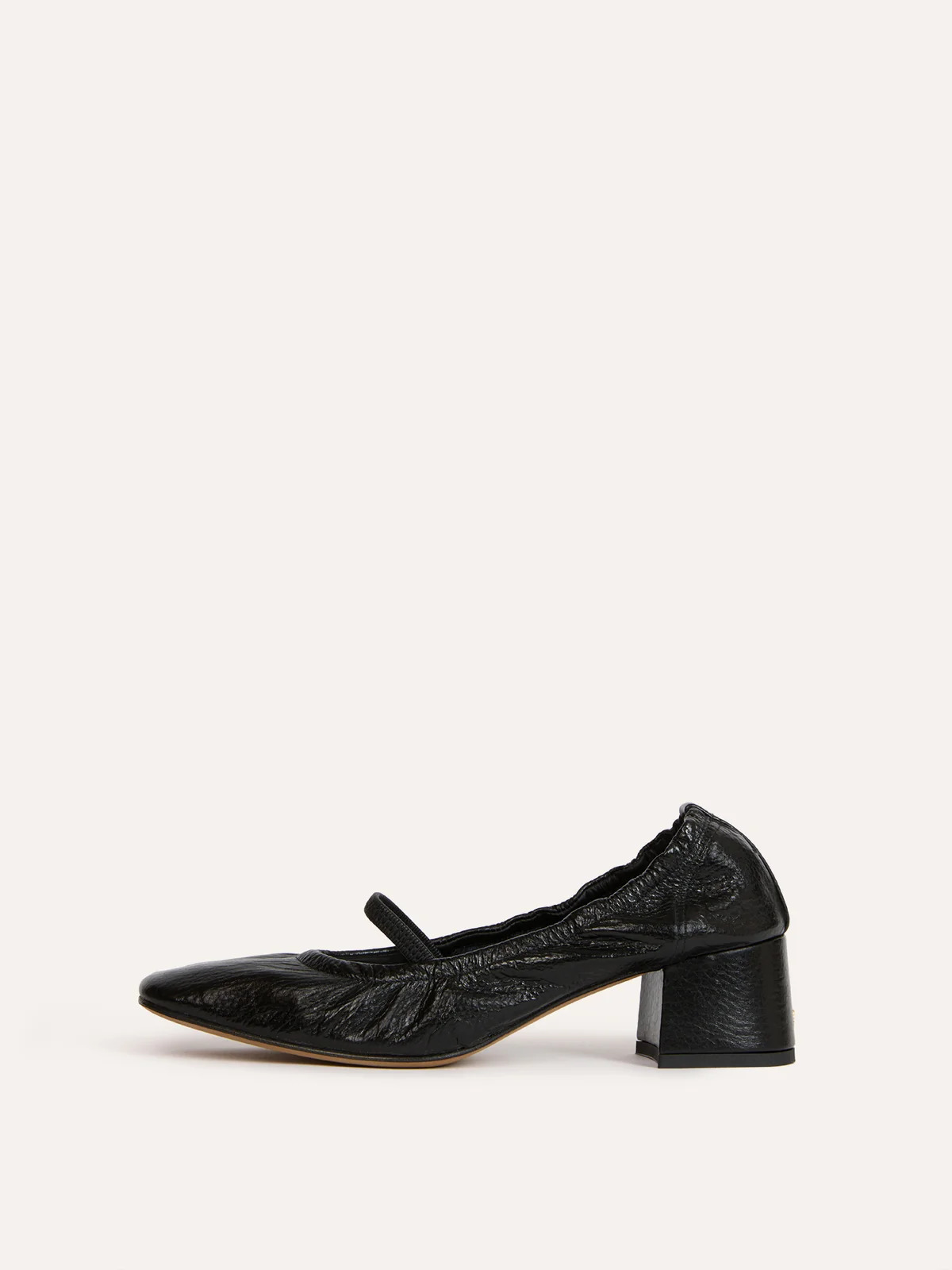 An image of a black heeled Mary Jane with cinched sock