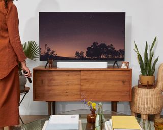 Sonos Beam in white on wooden TV cabinet