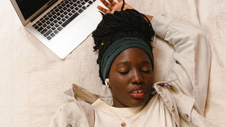 woman napping next to a laptop