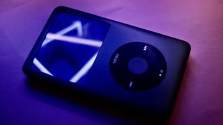 An old iPod under neon lighting