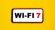Wi-fi 7 seen on a smartphone against a yellow background