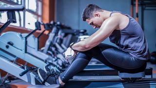 How to use a rowing machine: image shows man using rowing machine