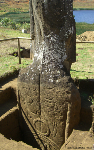 Back of one of the statues being excavated, showing petroglyphs.