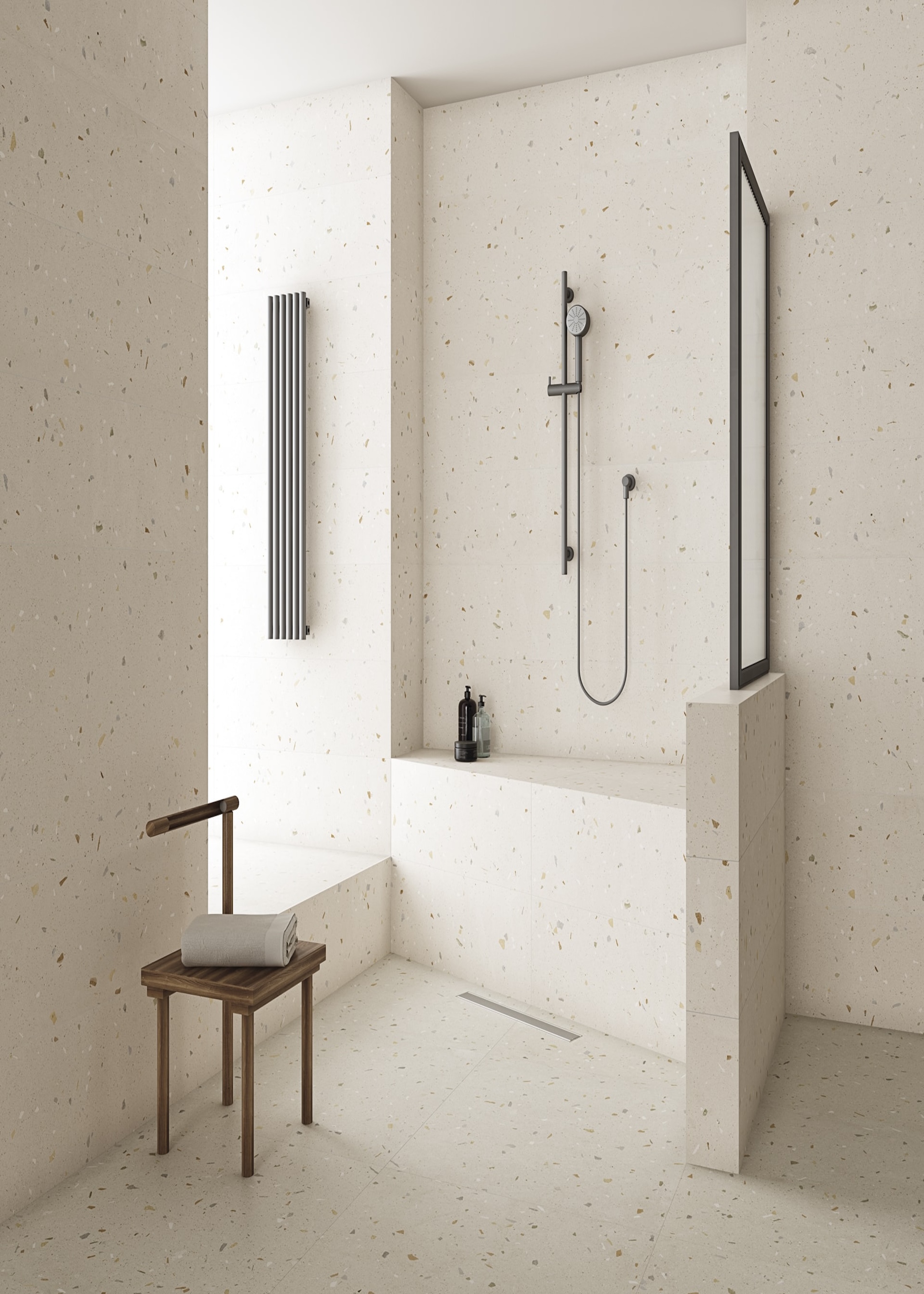 A sleek modern bathroom showing the same large terrazzo tiles on floors and walls