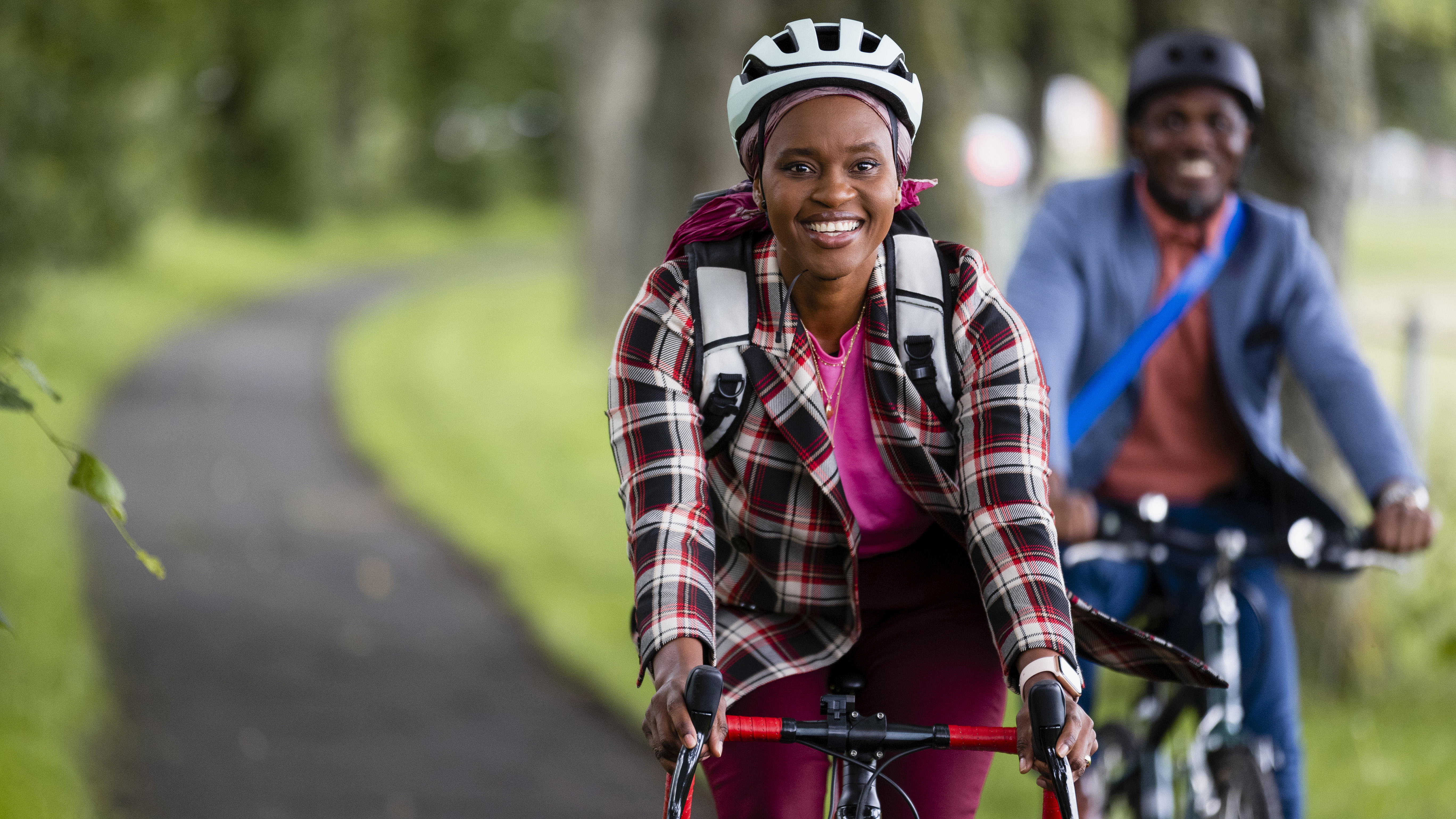 A smiling couple cycle commuting