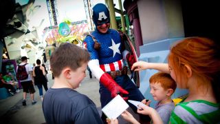 Captain America signing autographs for kids at Marvel Superhero Island