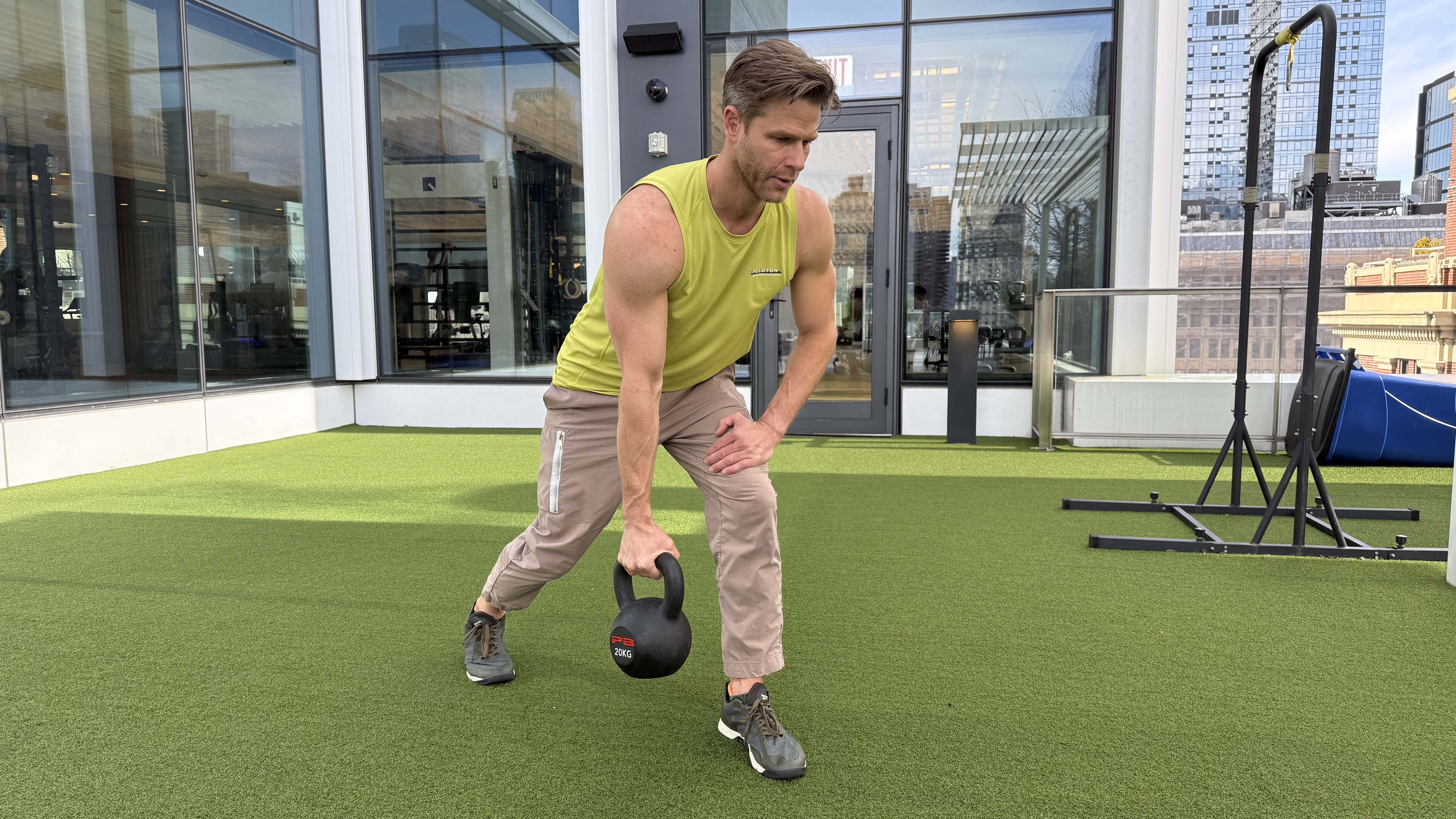 a photo of Peloton trainer Andy Speer doing a kettlebell single-arm row