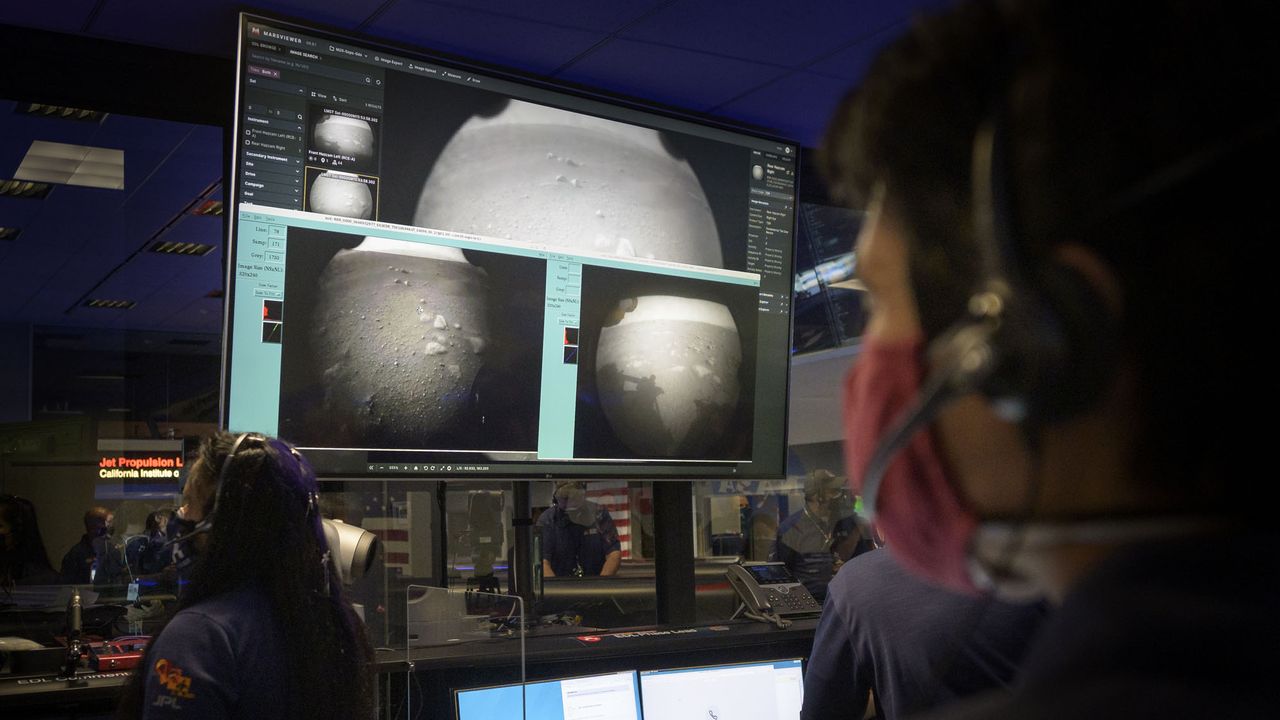 Members of NASA&rsquo;s Perseverance Mars rover team watch in Mission Control at NASA's Jet Propulsion Laboratory in Southern California as the first images arrive moments after the spacecraft successfully touched down on Mars, on Thursday, Feb. 18, 2021.