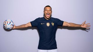 French player Mbappe posing with a football.