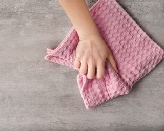 Wiping table with pink cloth