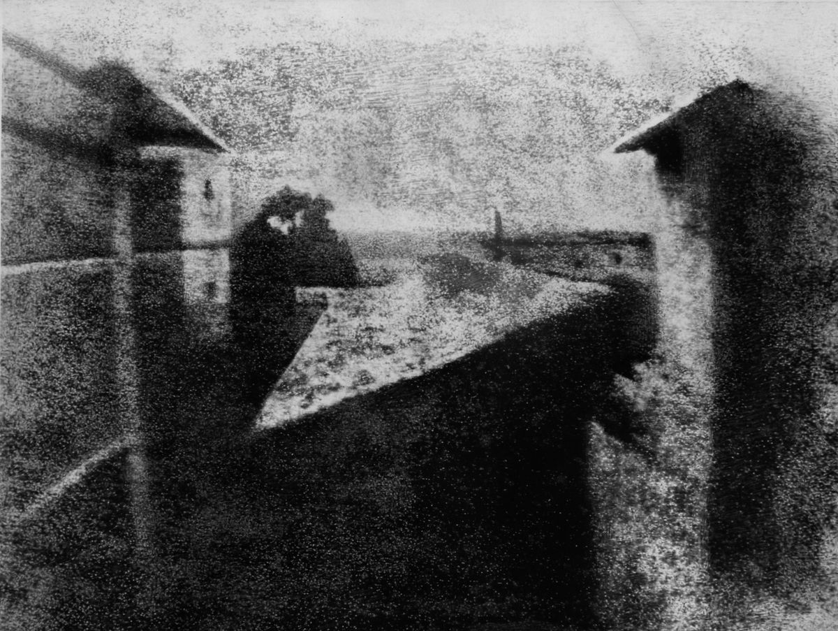 The world&#039;s first photograph by Joseph Niepce. Taken from a window of his Le Gras estate at Saint-Loup-de-Varennes, France, it was produced by exposing a bitumen-coated pewter plate in a camera obscura. It took an exposure time of eight hours.