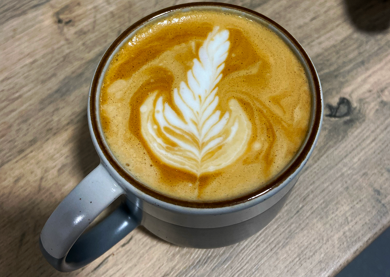 a photograph of latte with rosetta latte art