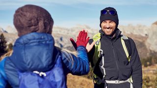 Man and woman high-fiving during hike