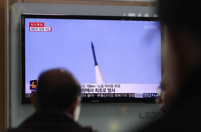 A TV displays a North Korean missile launch
