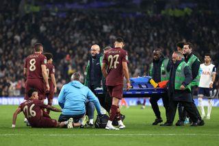 LONDON, ENGLAND - OCTOBER 30: Savinho of Manchester City is given treatment following an injury during the Carabao Cup Fourth Round match between Tottenham Hotspur and Manchester City at Tottenham Hotspur Stadium on October 30, 2024 in London, England. (Photo by Alex Pantling/Getty Images)