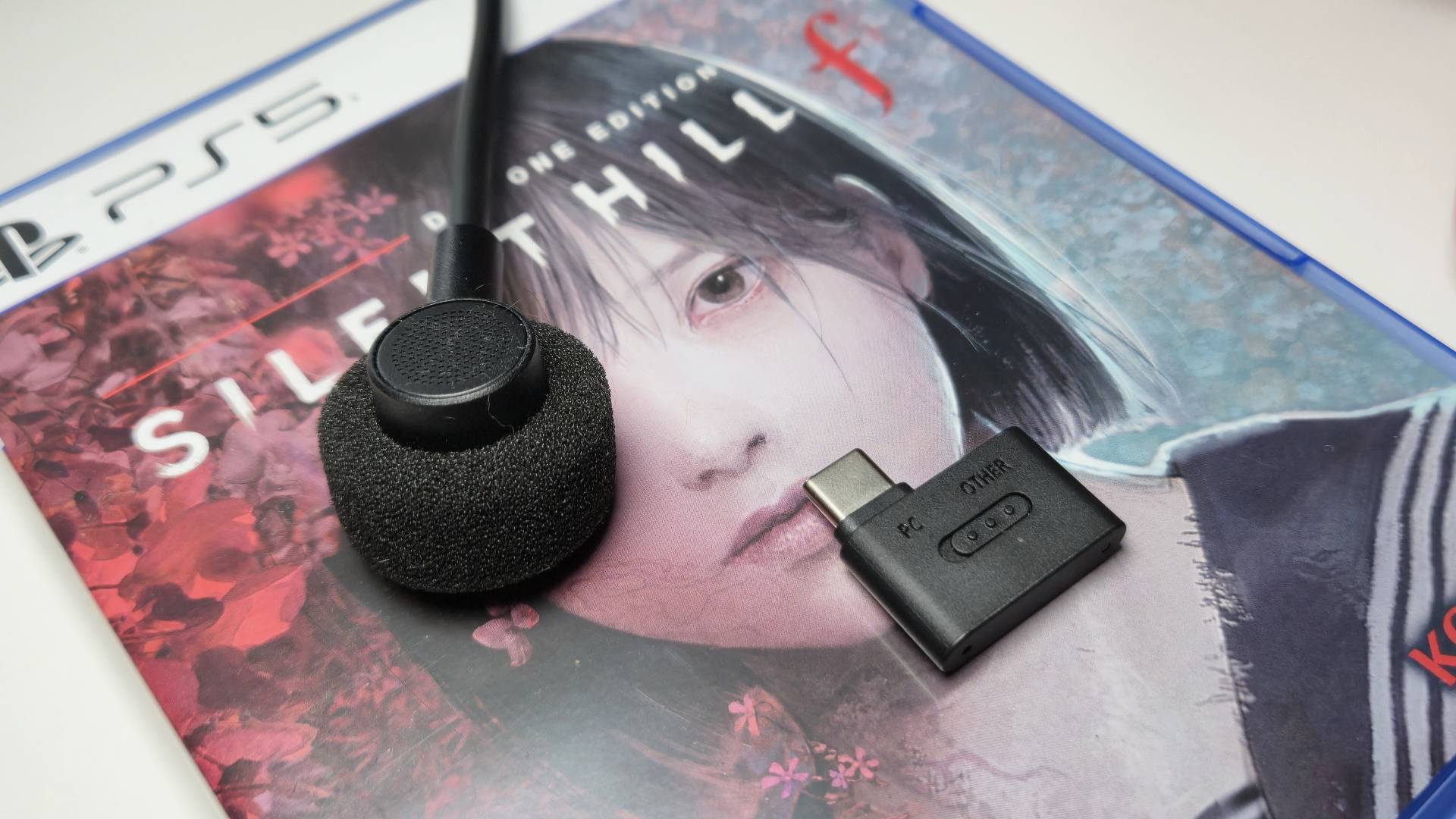 Close up of the H9 II microphone and wireless dongle, sitting on the PS5 game box for Silent Hill f.