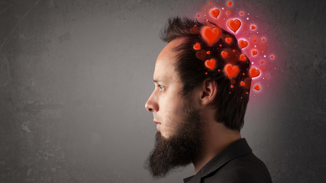 A bearded man with hearts around his head