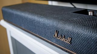 A Marshall Heston 120 soundbar on a TV stand.