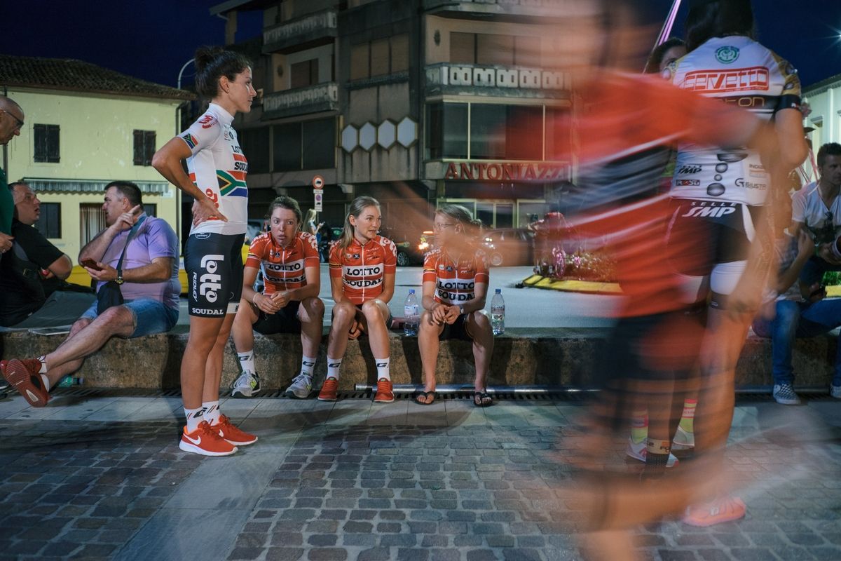 An-Li Kachelhoffer chooses to stand as her teammates take a seat