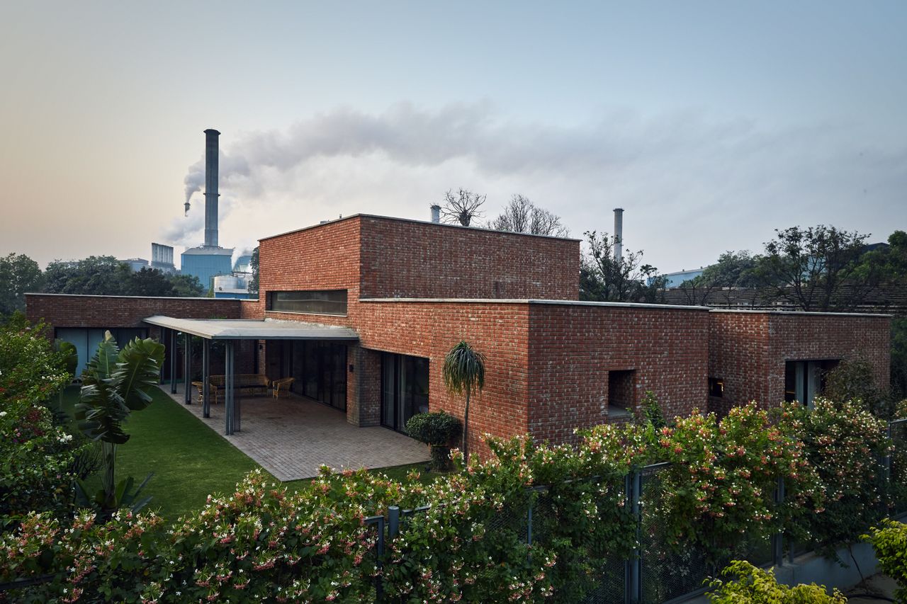 Exterior of Rajiv Saini&#039;s Dhampur House with factory in the background