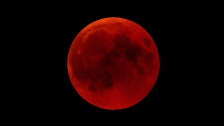 a blood-red moon on a black background