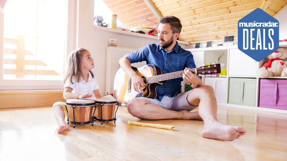 Man and daughter playing music in a playroom