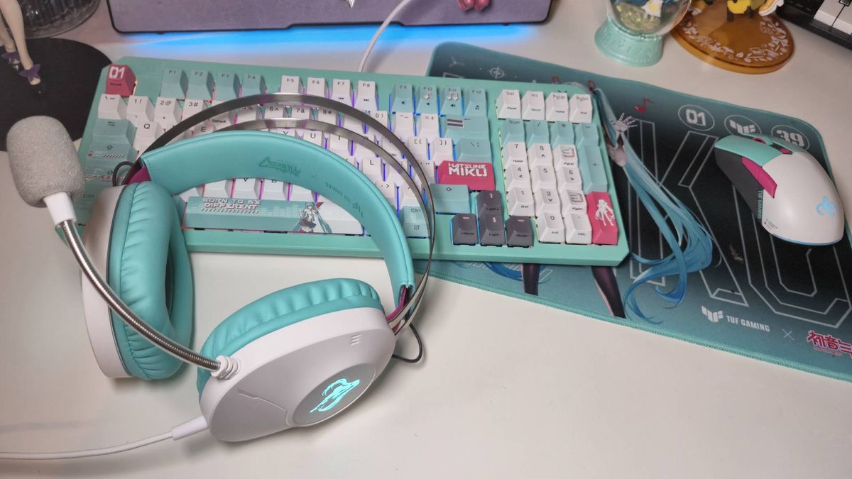 Photo of the Asus TUF Gaming Hatsune Miku collection sitting on a white desk.
