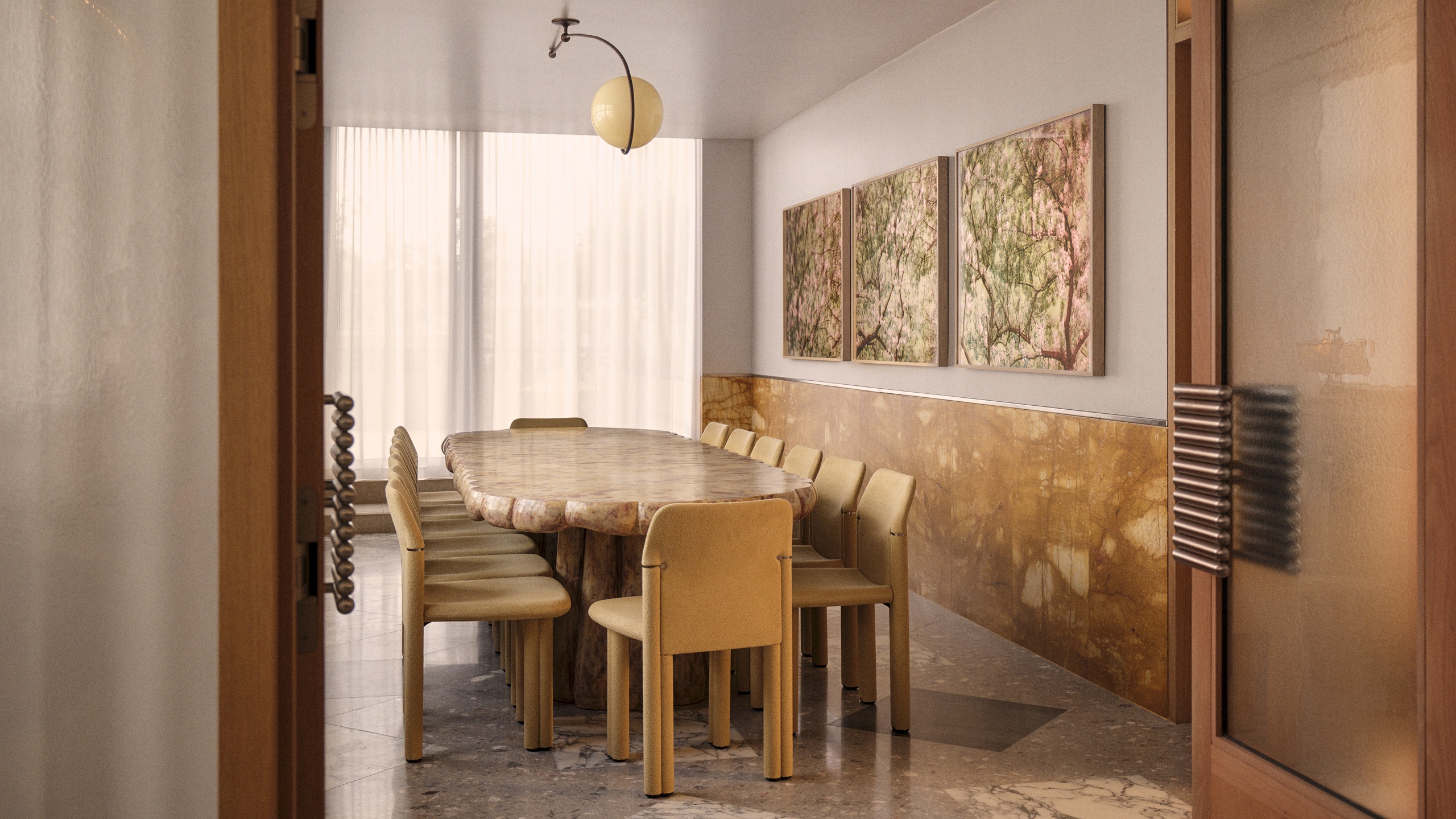 a dining room with a wood table and a brown tiled wall with art