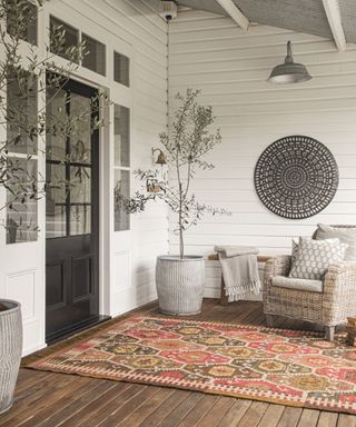 Fall porch with rug and wall decoration