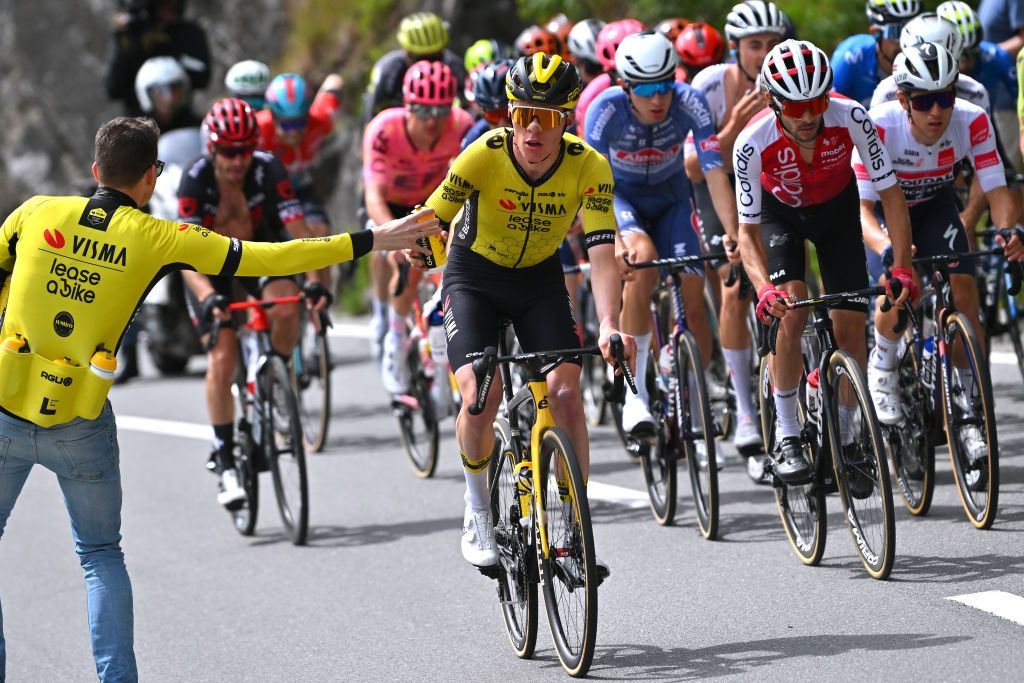 LEYSIN SWITZERLAND APRIL 27 Johannes StauneMittet of Norway and Team Visma Lease a Bike picks bottles from a team soigneur during the 77th Tour De Romandie 2024 Stage 4 a 1592km stage from Saillon to Leysin 1314m UCIWT on April 27 2024 in Leysin Switzerland Photo by Luc ClaessenGetty Images