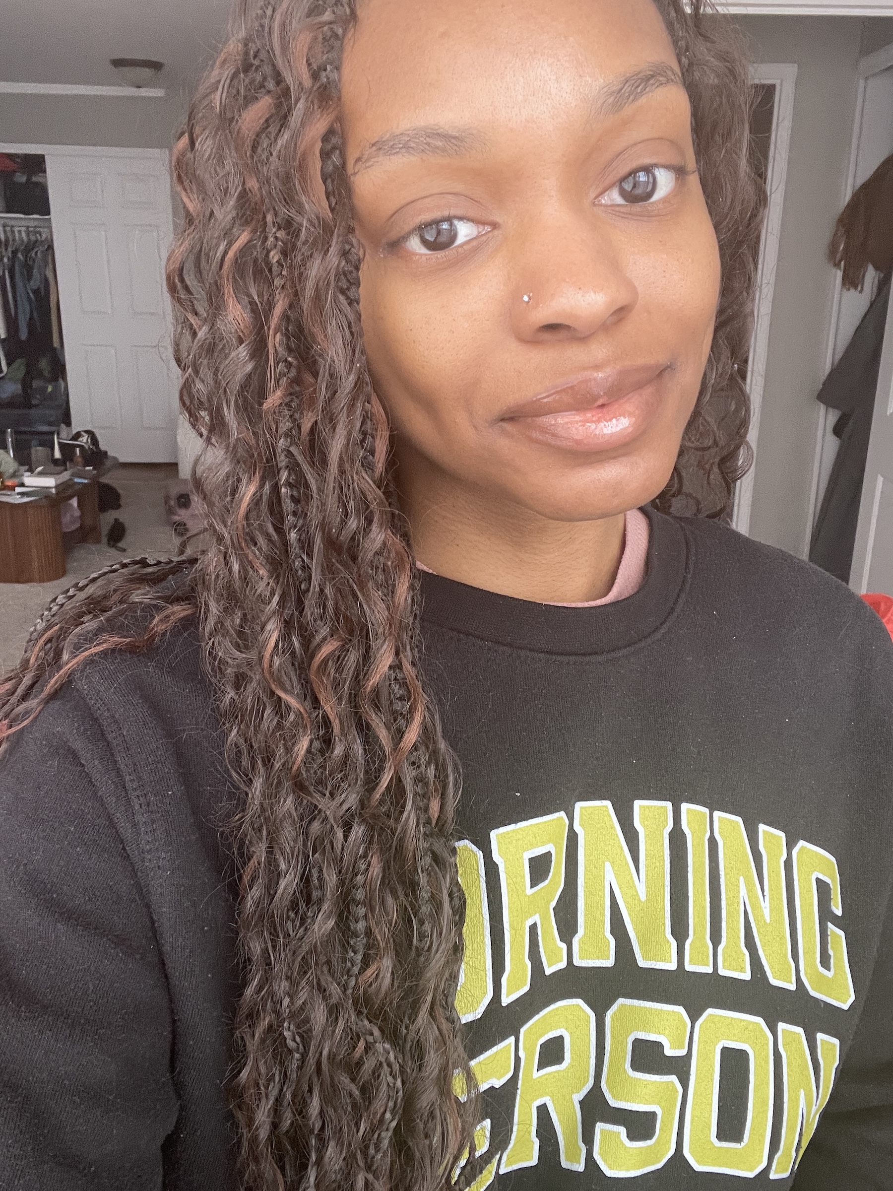 a before image of a black woman testing a black liquid eyeliner